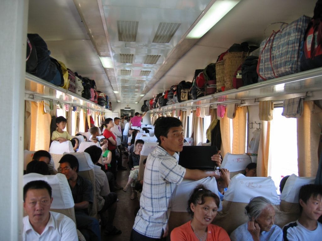 Drukke gang van een Chinese harde slaapwagon volgeladen met bagage op de rit naar Dunhuang