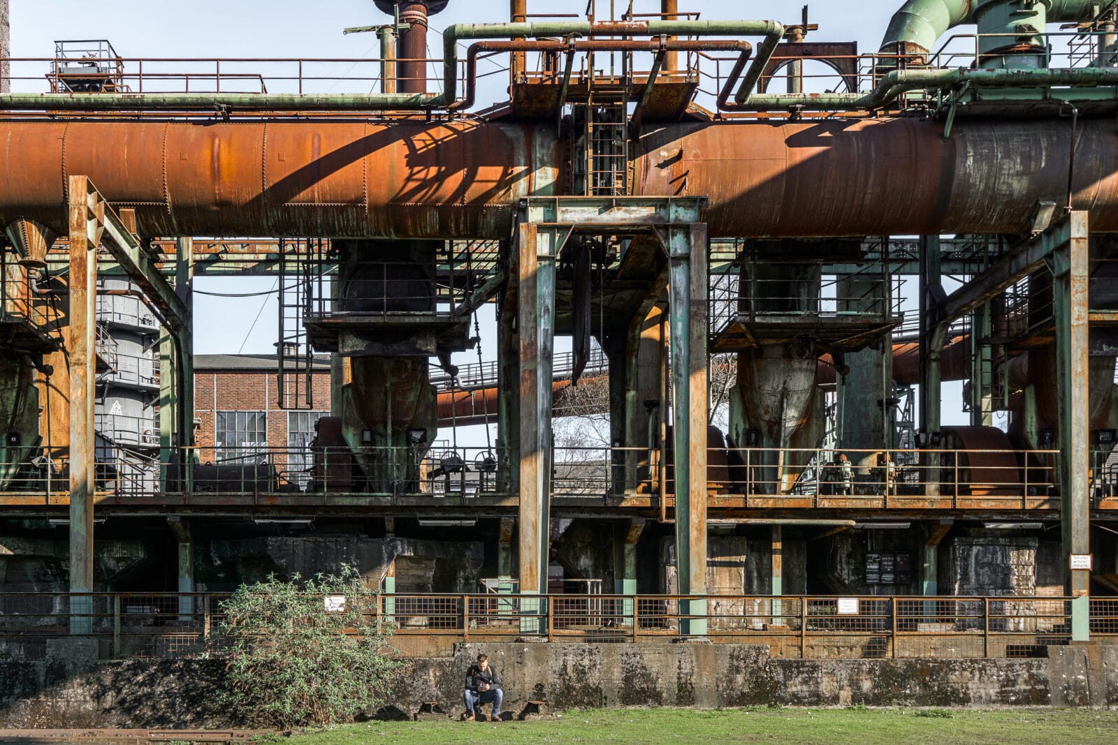 Man alleen tussen het roest van de oude hoogovens, Duisburg-Meiderich