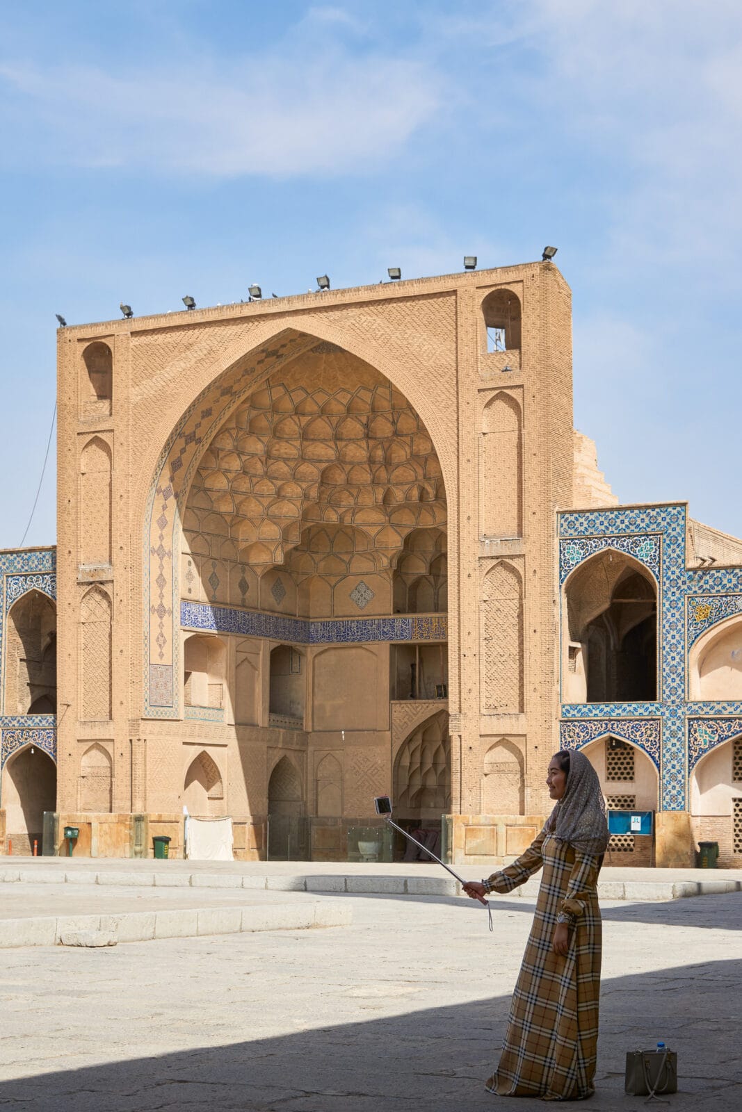 Vrouw maakt een selfie voor een historische moskee in Isfahan