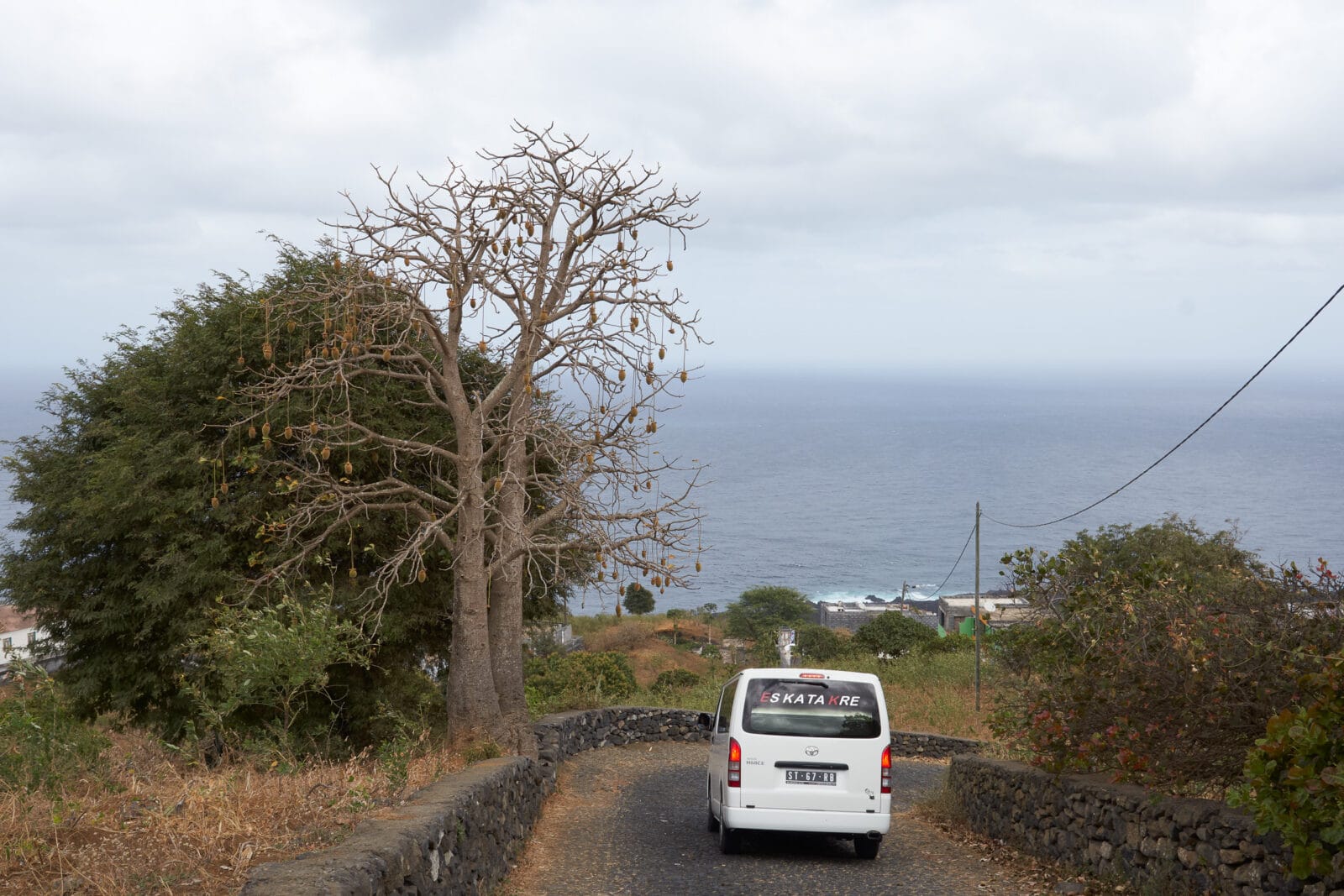 Witte bus op de kronkelweg boven de kust bij Mosteiros