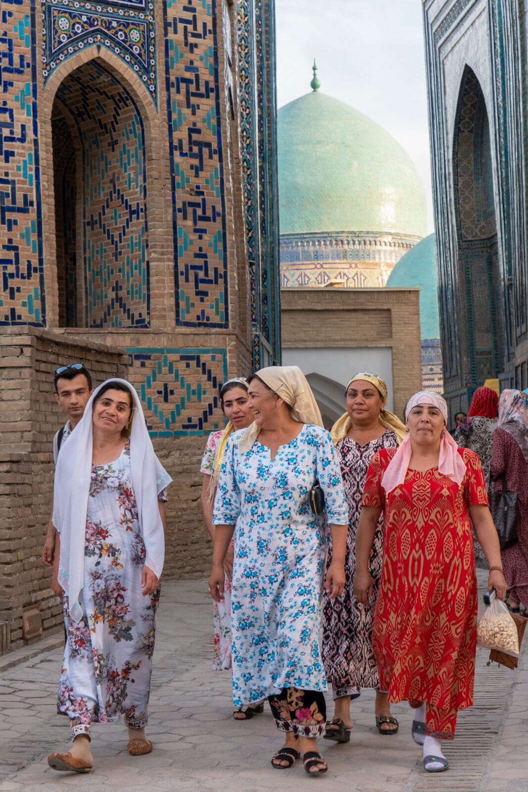 Vrouwen lopen langs de mausolea van de Sjah-i-Zinda in Samarkand