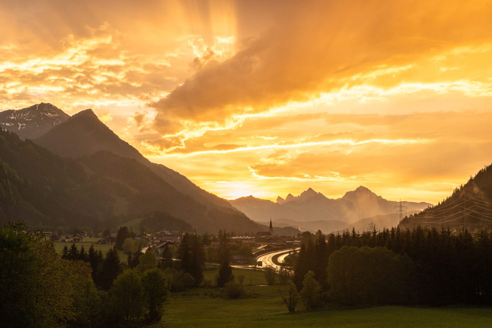 Zonnestralen door het wolkendek boven het dal bij Bichlbach