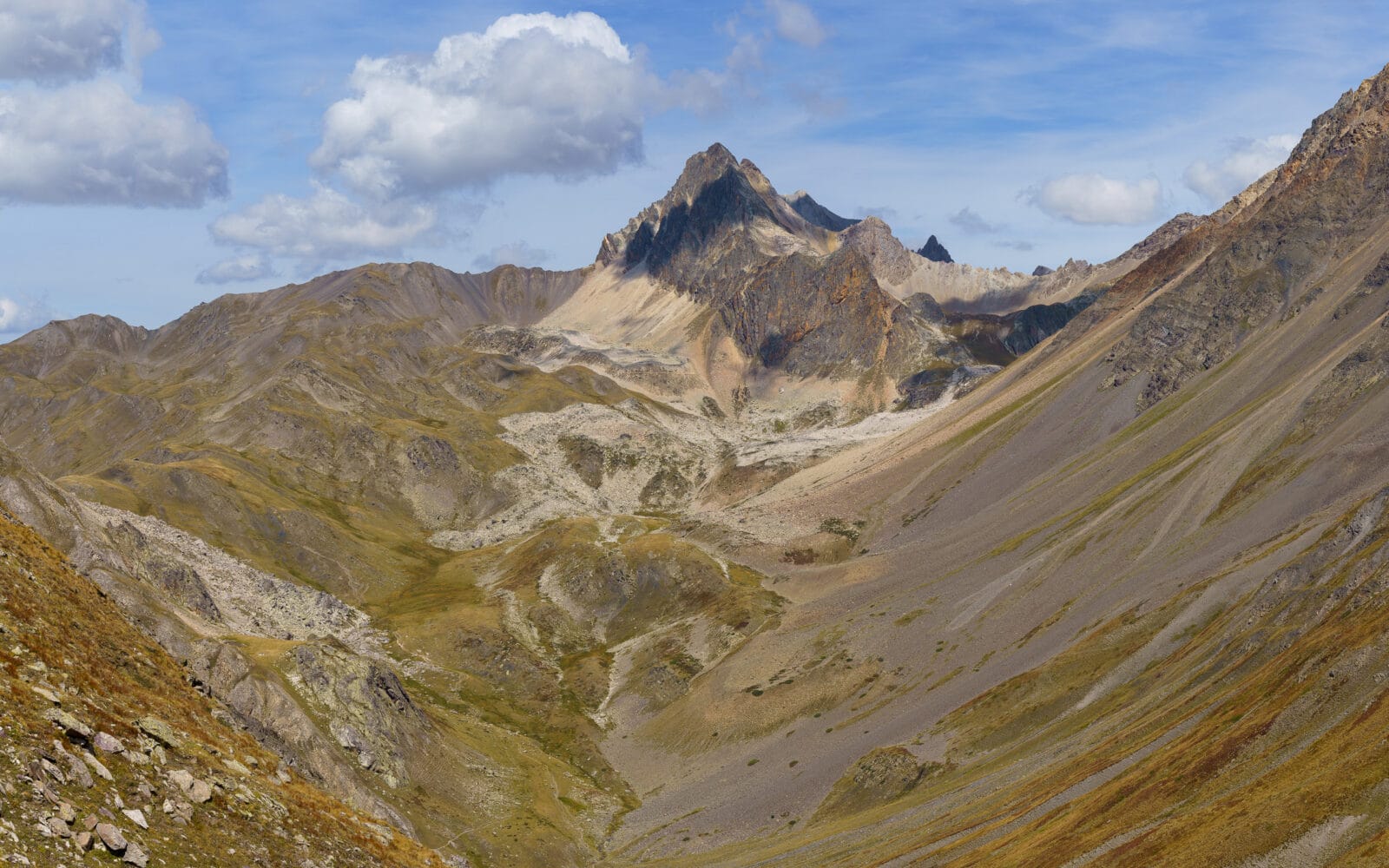Ruige berghellingen onder een bewolkte hemel bij Le Monêtier-les-Bains