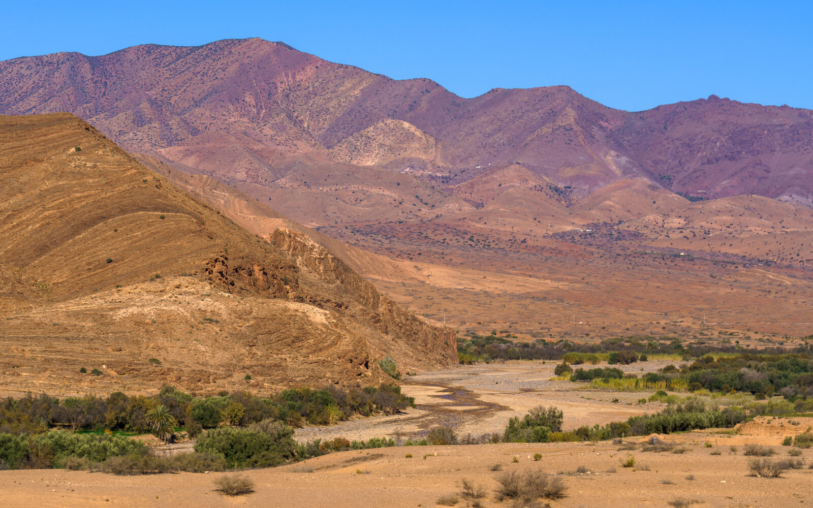 Arid mountains meet a green oasis valley