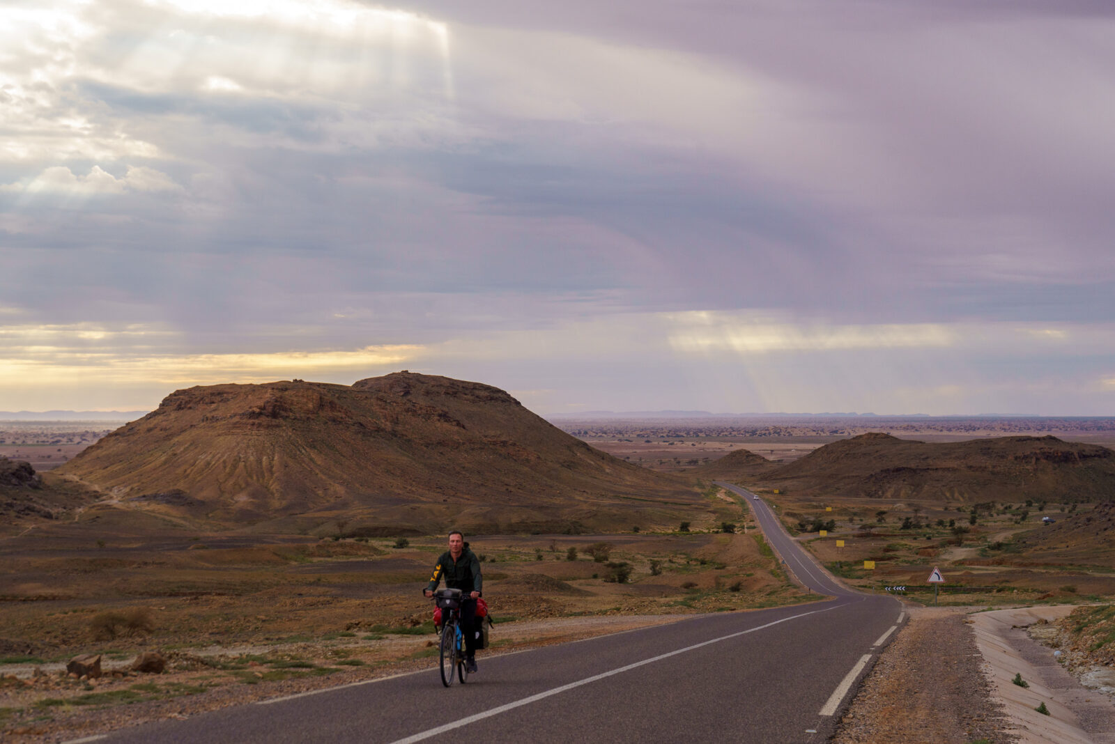 Cyclist rides on a lonely desert road