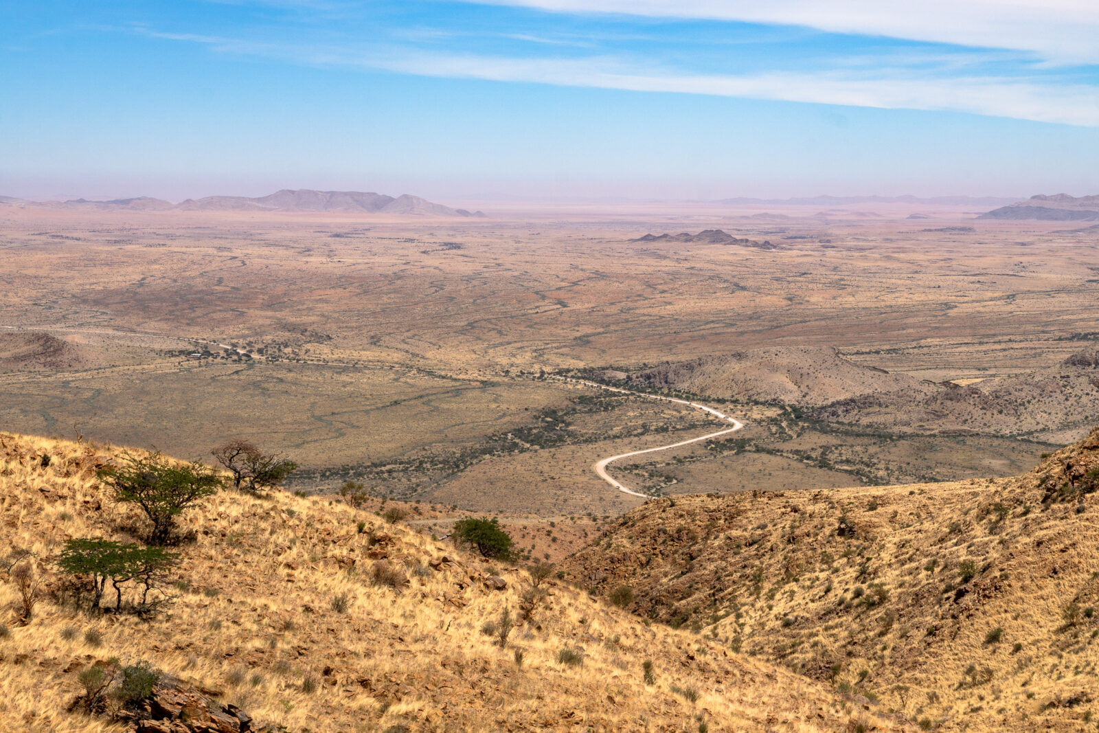 Desert road winding into the hazy horizon