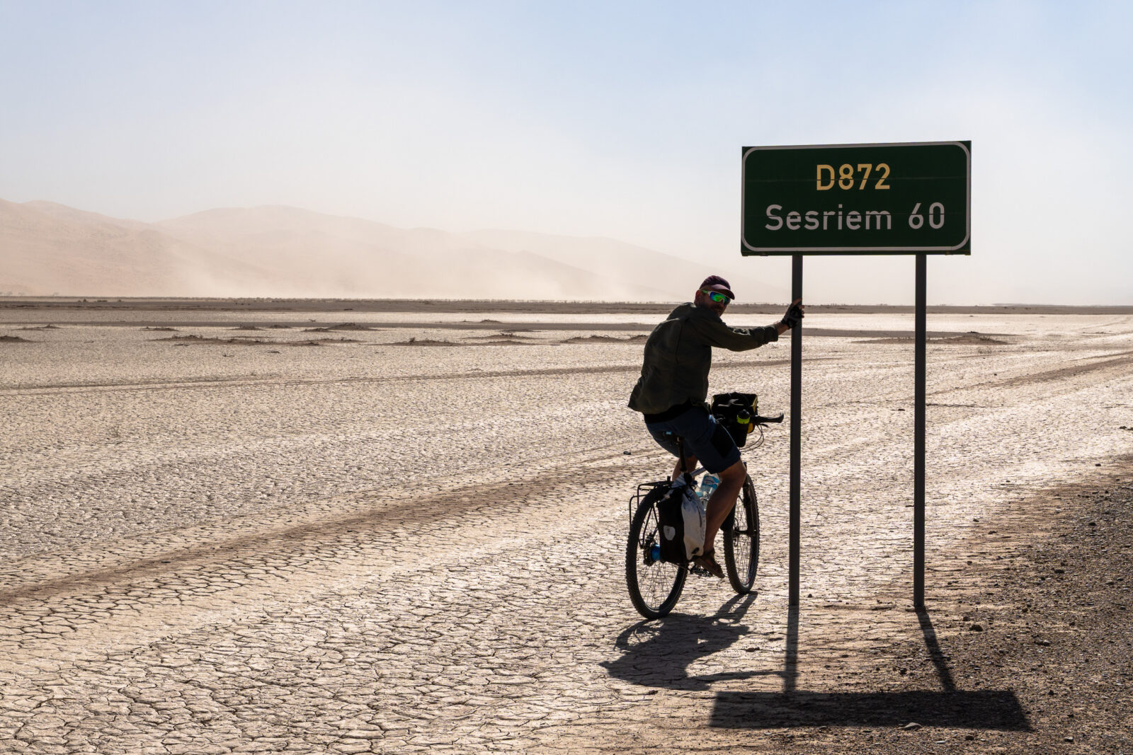 Solitary ride through the cracked desert