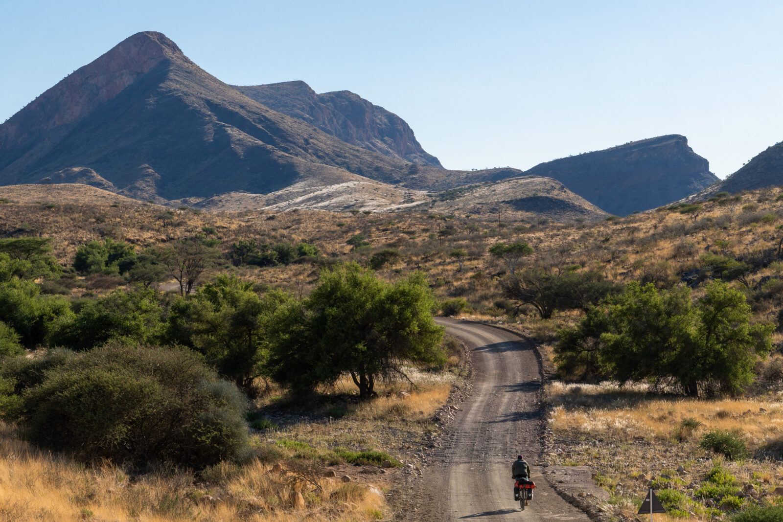 Solitary ride through vast desert mountains