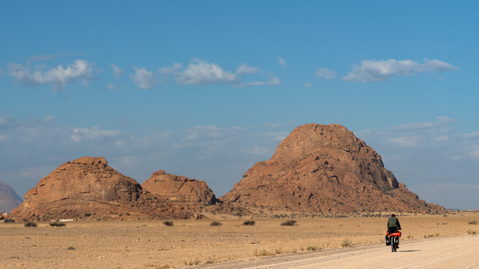 Solitary ride through ancient desert peaks