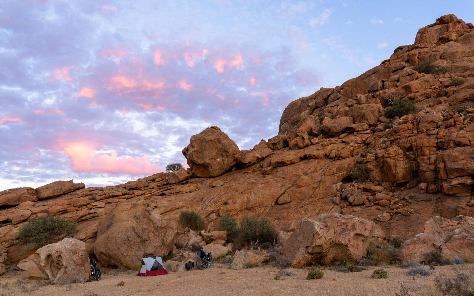 Pink clouds grace a rugged desert camp