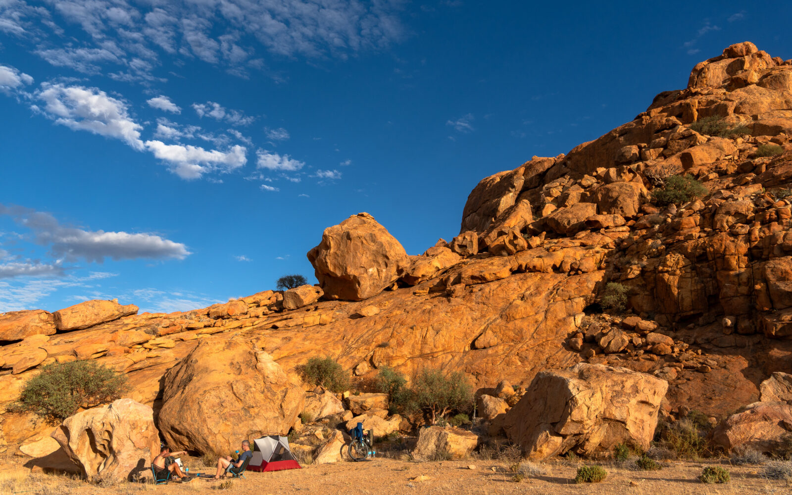 Peaceful desert camp nestled among golden rocks